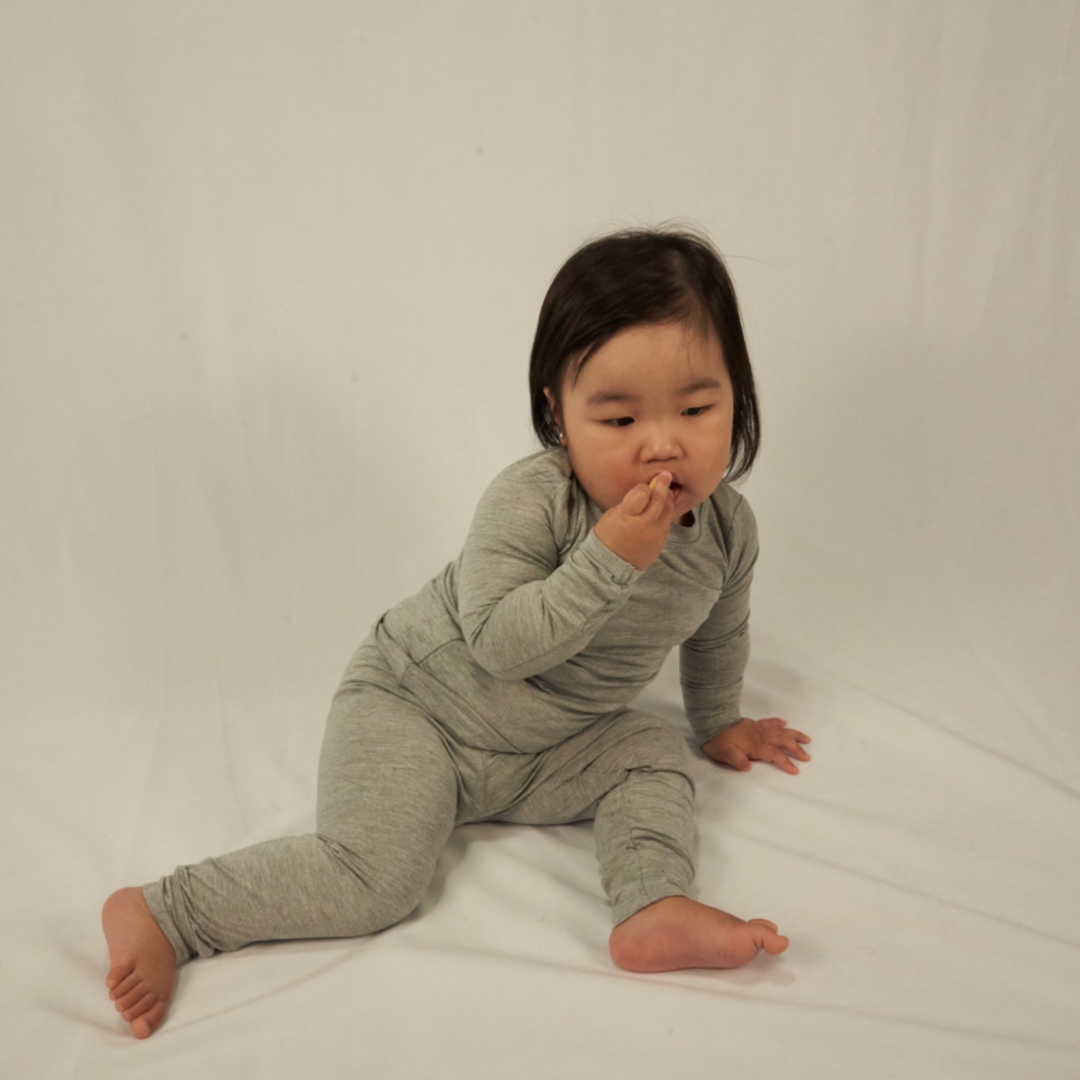 Olivia wearing her toddler set in color slate/grey